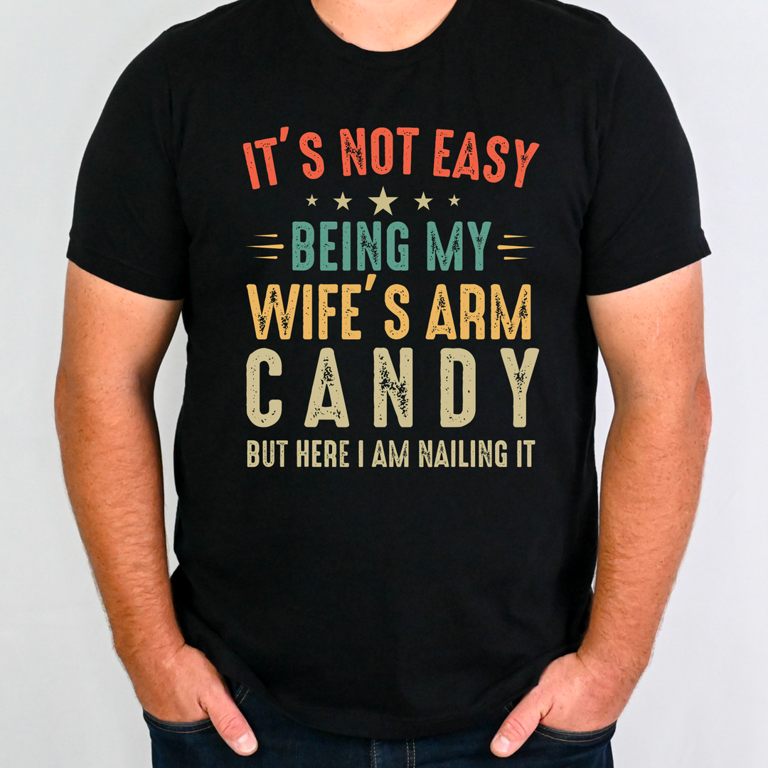 It’s Not Easy Being My Wife's Arm Candy BELLA CANVAS BLACK Tee