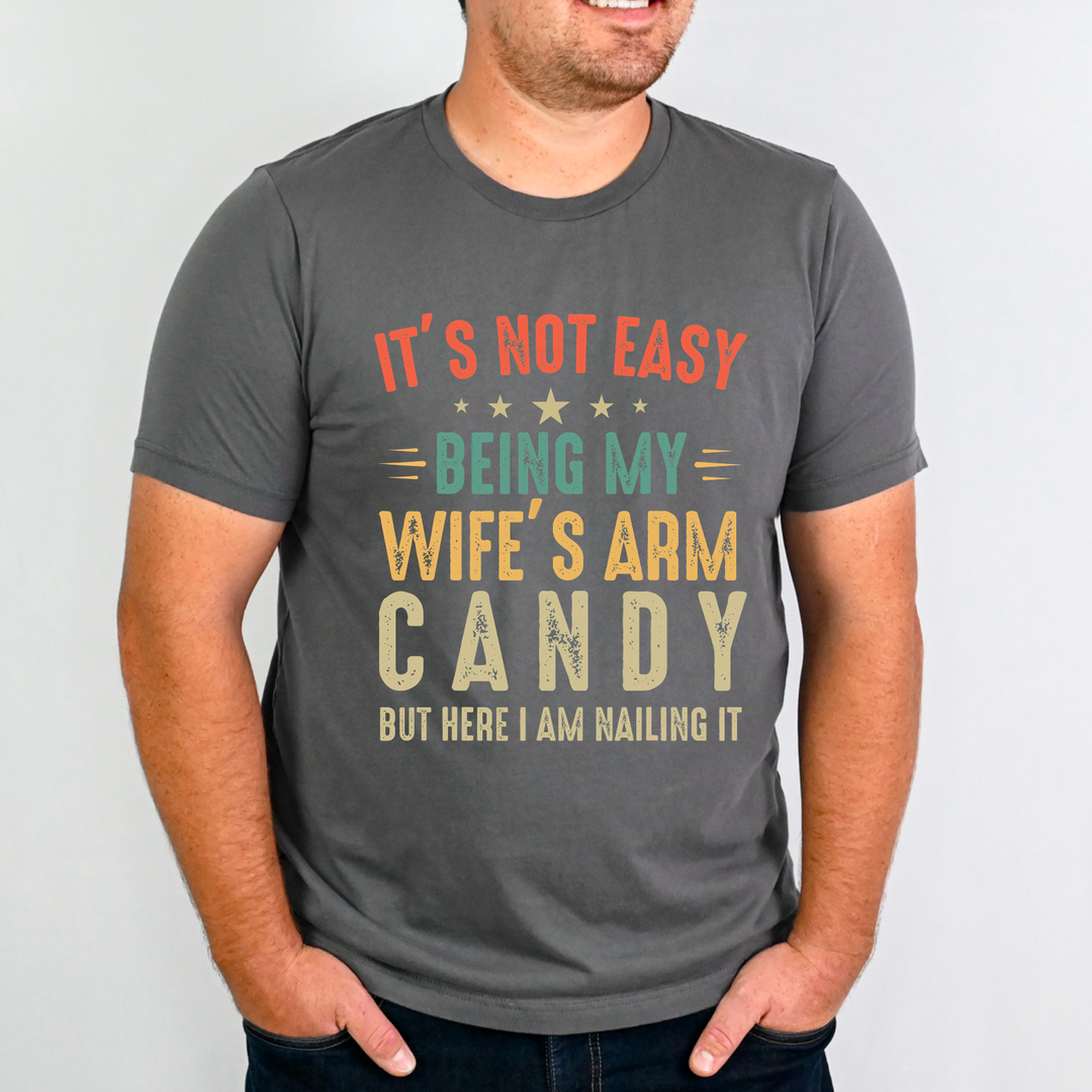 It’s Not Easy Being My Wife's Arm Candy GILDAN SOFTSTYLE CHARCOAL Tee